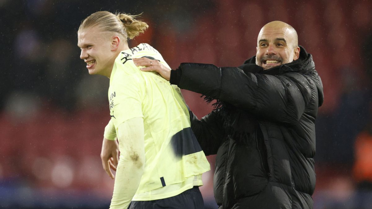 City's head coach Pep Guardiola, right, and City's Erling Haaland celebrate their victory over Crystal Palace, March, 11, 2023.