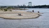 People enjoy the sunny weather on dry river banks of Germany's most important river Rhine in Cologne, Germany, after a long time of drought, 27 April 2020.