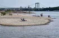 People enjoy the sunny weather on dry river banks of Germany's most important river Rhine in Cologne, Germany, after a long time of drought, 27 April 2020.
