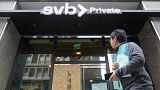 A pedestrian passes a Silicon Valley Bank branch in San Francisco, Monday, March 13, 2023.