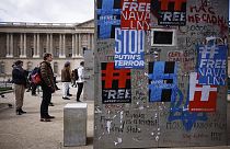 People watch a replica of Russian opposition leaderAlexei Navalny jail cell installed on a square near the Louvre Museum in Paris, Tuesday, March 14, 2023