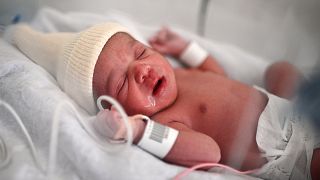 A new-born baby lies in an incubator moments after her birth in Paris. France has the highest fertility rate in the EU.