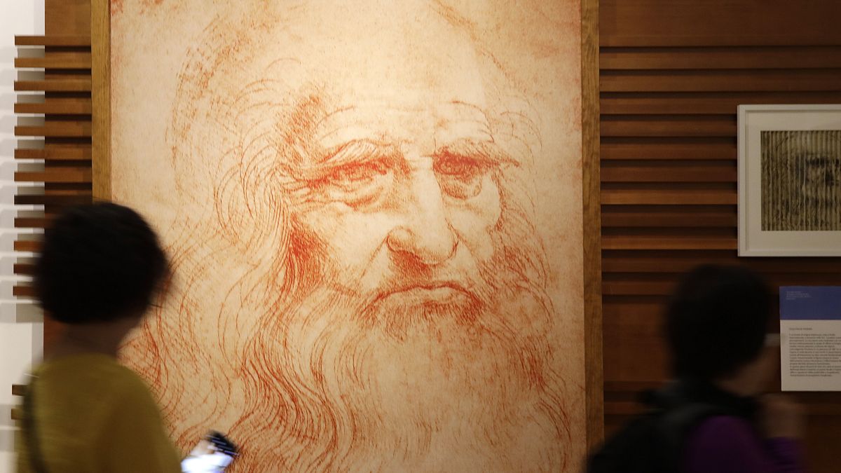 Visitors look at a self-portait of Leonardo Da Vinci at an exhibtion in Rome