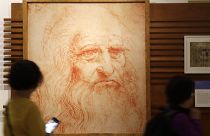 Visitors look at a self-portait of Leonardo Da Vinci at an exhibtion in Rome