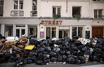 Uncollected garbage is piled up on a street in Paris