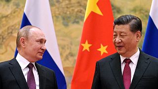 FILE - Chinese President Xi Jinping, right, and Russian President Vladimir Putin talk to each other during their meeting in Beijing, China on Feb. 4, 2022.