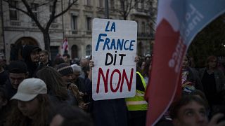 A woman holds a sign reading "France says no" during a demonstration in Marseille. 16 March, 2023