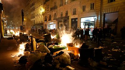 Garbage is set on fire by protesters after a demonstration near Concorde square, in Paris