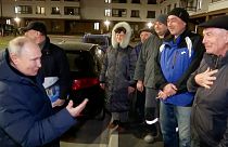 Russian TV Pool on Sunday, March 19, 2023, Russian President Vladimir Putin talks with local residents during his visit to Mariupol