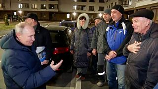 Russian TV Pool on Sunday, March 19, 2023, Russian President Vladimir Putin talks with local residents during his visit to Mariupol
