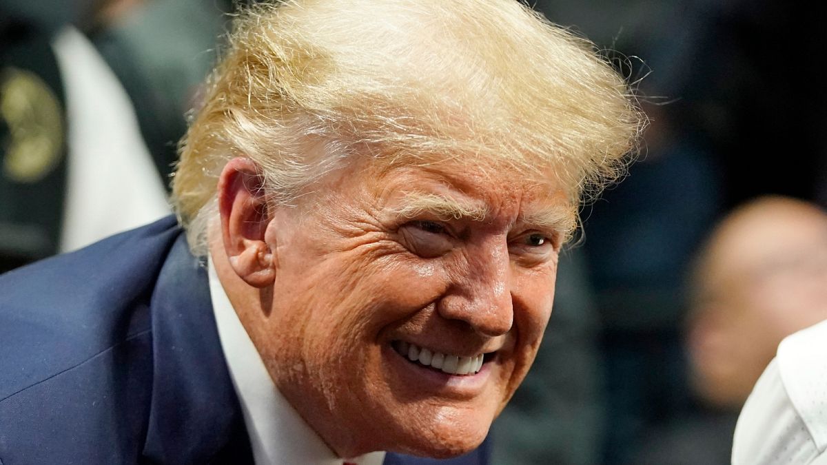 Former President Donald J. Trump smiles as he poses for a photo at the NCAA Wrestling Championships, Saturday, March 18, 2023, in Tulsa, Okla.