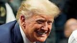 Former President Donald J. Trump smiles as he poses for a photo at the NCAA Wrestling Championships, Saturday, March 18, 2023, in Tulsa, Okla.