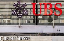 Logos of the Swiss banks Credit Suisse and UBS are seen on two buildings in Zurich, Switzerland, Saturday, March 18, 2023. 