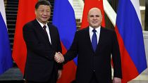 Russian Prime Minister Mikhail Mishustin, right, and Chinese President Xi Jinping pose for a photo during their meeting in Moscow, Russia, Tuesday, March 21, 2023. 