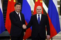 Russian Prime Minister Mikhail Mishustin, right, and Chinese President Xi Jinping pose for a photo during their meeting in Moscow, Russia, Tuesday, March 21, 2023. 