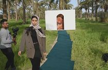 A model promotes green fashion at a palm-grove catwalk show in Iraq. March 21, 2023