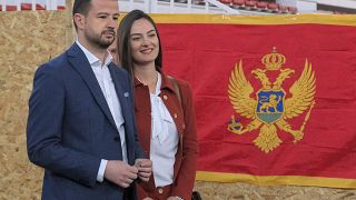 Economist Jakov Milatovic of the newly-formed Europe Now group, left, and his wife Milena wait at the polling station in Montenegro's capital Podgorica, Sunday, March 19, 2023