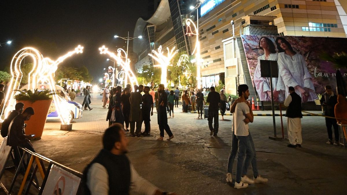 Des habitants d'Islamabad (Pakistan) devant un centre commercial après le séisme, le 21 mars 2023.