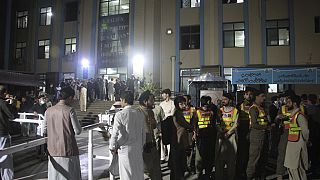 Rescue workers and people gather at a hospital, where earthquake victims are brought, in Saidu Sharif, a town Pakistan's Swat valley, Tuesday, March 21, 2023