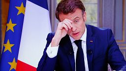 A drawing of French President Emmanuel Macron reading « Macron , we are not your buffoons» is pictured during a protest at Republique square in Paris, Tuesday, March 21, 2023.