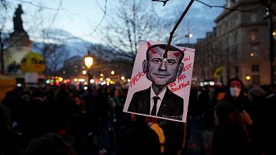 A drawing of French President Emmanuel Macron reading « Macron , we are not your buffoons» is pictured during a protest at Republique square in Paris, Tuesday, March 21, 2023.