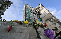Flowers laid on a destroyed building in Ukraine. 