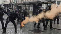 A riot police officer shields from an incoming flare during a protest in Rennes, western France, March 22, 2023.