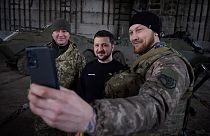 Ukrainian president poses for selfies with military personnel.