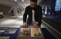 Christopher Lynch, music historian at the University of Pittsburgh, adjusts photos of Gospel music composer, Charles Henry Pace