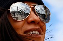 The Olympic rings are reflected on sunglasses, on Trocadero plaza that overlooks the Eiffel Tower in Paris.