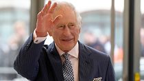 Britain's King Charles III waves as he arrives for a visit to the new European Bank for Reconstruction and Development (EBRD) in London, Thursday, March 23, 2023. 