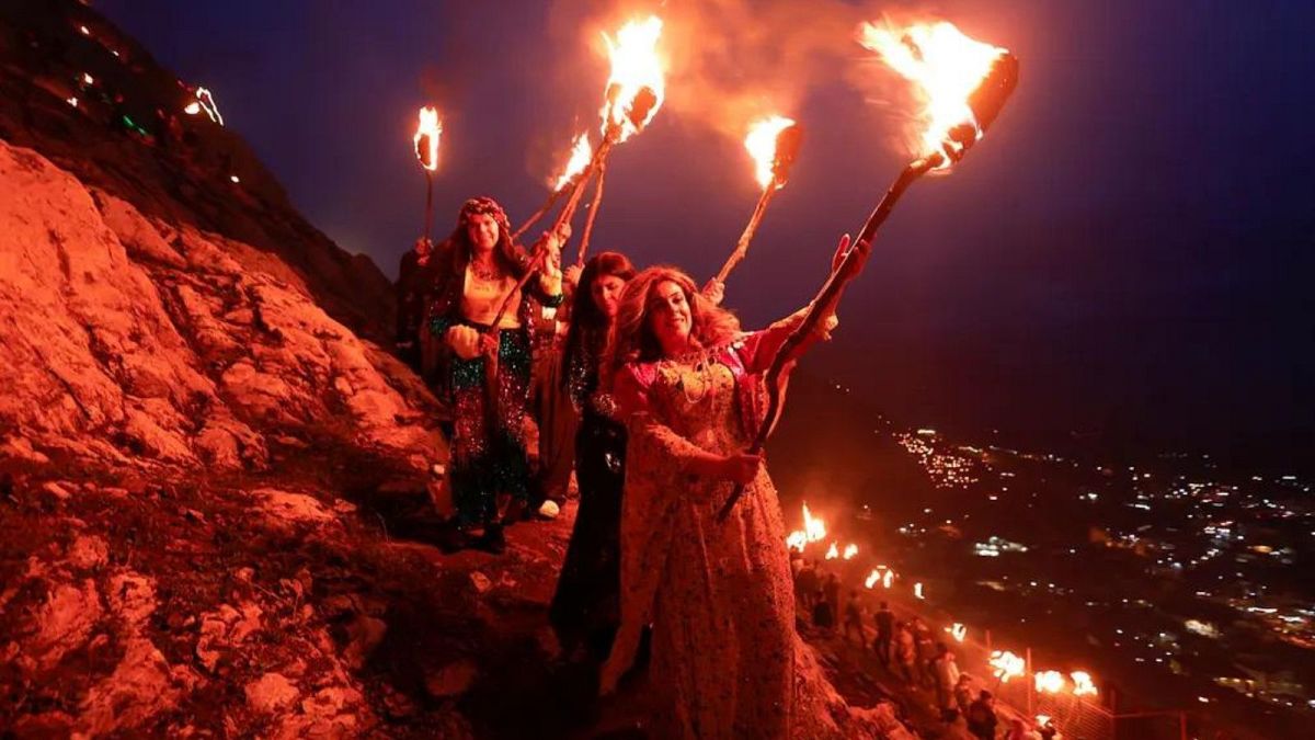 People carry torches during Nowruz celebrations - Akra, Iraq