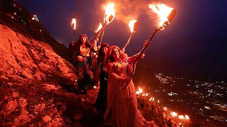 People carry torches during Nowruz celebrations - Akra, Iraq