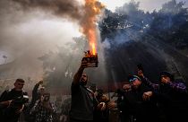 A protester launches fireworks at the Lebanese Central Bank building as frustrated depositors rally against Central Bank Gov. Riad Salameh, who is facing corruption charges.
