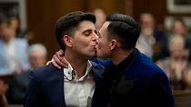 Sean Adl-Tabatabai, left, and Sinclair Treadway kiss each other after they were announced officially married during a wedding ceremony