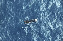 FILE: image by German humanitarian organisation Sea-watch shows a boat carrying a group of migrants in distress in the Southern Mediterranean Sea, March 11, 2023