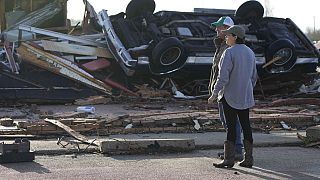 Residents inspect damage following Friday's deadly tornado in Mississippi. 