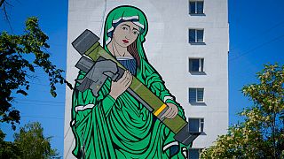 A mural depicts the Virgin Mary cradling a US-made Javelin missile on an apartment in Kyiv, Ukraine. 