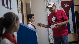 A man wearing a shirt with an image of Ernesto 'Che' Guevara prepares to vote at a polling station in Havana, Cuba, Sunday, March 26, 2023.