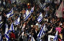Israelis opposed to PM Benjamin Netanyahu's judicial overhaul plan block a highway during a protest after the leader fired his defence minister, in Tel Aviv, March 26, 2023