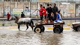 Iraqis make their way on a horse cart through a flooded street after heavy rain fell in Baghdad, Iraq, 20 November 2013.