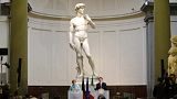 Former German Chancellor Angela Merkel and ex-Italian Prime Minister Matteo Renzi holding a press conference in front of Michelangelo's David in 2015.   -