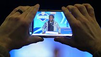 A journalist records Boston College wide receiver Zay Flowers as he speaks during a news conference  in Indianapolis, Friday, March 3, 2023. 