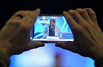 A journalist records Boston College wide receiver Zay Flowers as he speaks during a news conference  in Indianapolis, Friday, March 3, 2023.