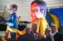 A carnival float depicts German chancellor Olaf Scholz in the clutches of China's leader Xi Jinping in Cologne, Germany.