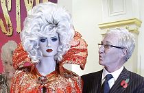 O'Grady standing next to a costume of his alter ego Lily Savage - Liverpool's Walker Art Gallery