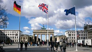 From left, the German flag, the Union Jack flag and the EU flag at Brandenburg Gate, Berlin. March 2023