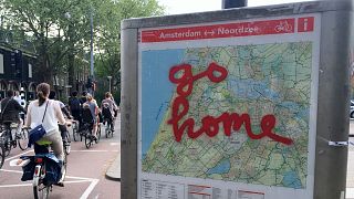 Graffiti reading "Go Home" is sprayed on a map of bicycle paths at the entrance to Amsterdam's Vondelpark, a popular spot for tourists to ride their rental bicycles. 
