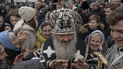 Ein hoher Priester der ukrainisch-orthodoxen Kirche segnet Gemeindemitglieder im Kiewer Klosterkomplex Pechersk Lawra in Kiew am 29. März 2023.