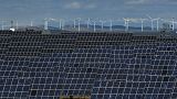 Solar panels work near the small town of Milagro, Navarra Province, northern Spain, on Feb. 24, 2023. 